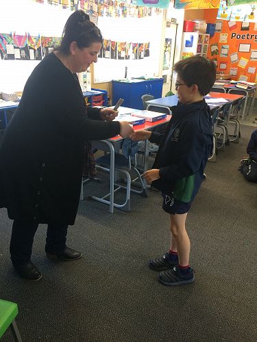 Ryan Zhou receiving a Columba pin and special pens