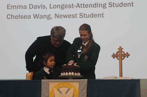 Mrs Duthie, Emma Davis and Chelsea Wang cut the Saint Columba Day cake