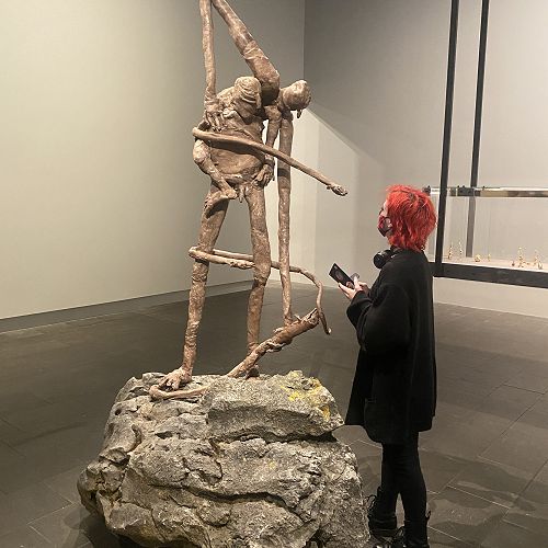 Micayla Merritt studies a Francis Upritchard sculpture
