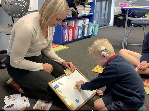 Louie creating words on whiteboard