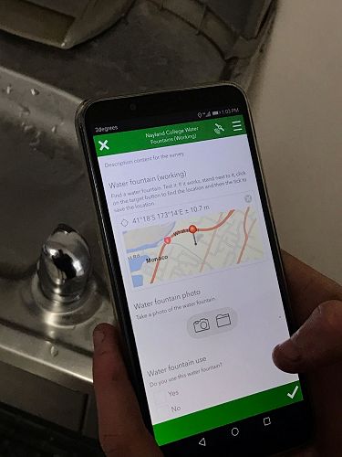 A student conducts a water fountain survey using Survey 123 for ArcGIS. 