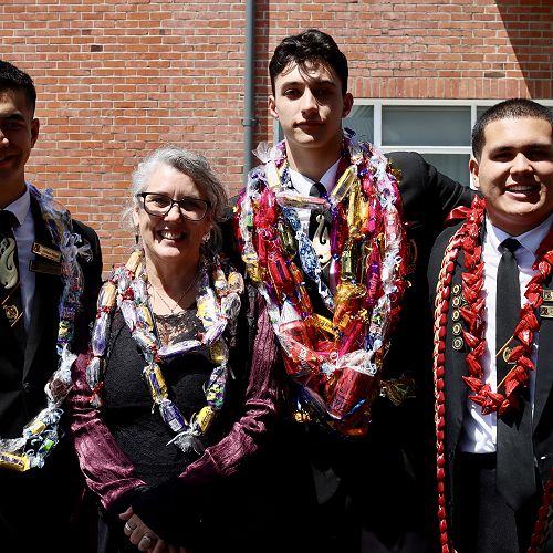 Miss Phillipa Grace with Hohaia Keogh, Nauvoo Dixon, and Natthanael Lavasi'i at Senior Prize Giving 2022