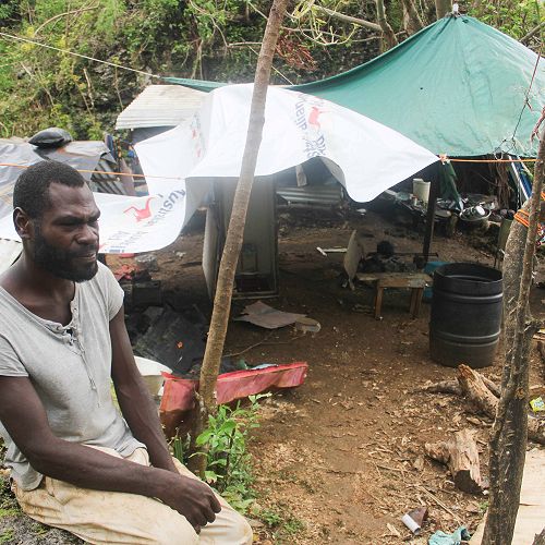 Andrew and Anna lost their home in Cyclone Judy.  Andrew sits outside the makeshift shelter where he is staying until he has rebuilt his home.  His family are living in the VCC Evacuation Centre.