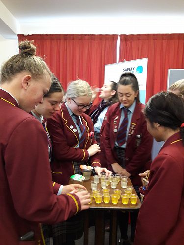 Students testing liquids at Timaru Hospital during Speech Language information session