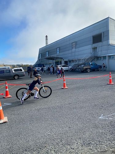 Ruby Mcllroy finishing her bike leg and heading in to tag her team mate Ailie Somerville for the final swim stage