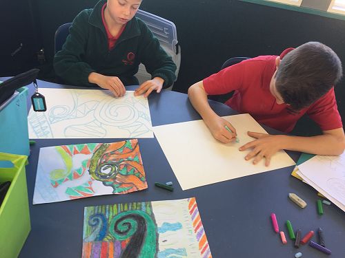 Felix and Sam concentrating on their designs.