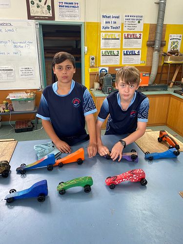 Iree and Kevin prepare the dragsters for the race.