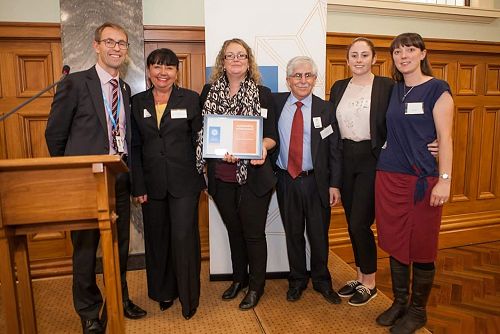Ashley Bloomfield, Director General of Health, presenting the Minister of Health Outstanding Achievement Award to the Volunteer Team at Camp Purple Live.