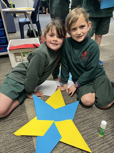 Matilda and Eve's excellent teamwork in making a paper star for Matariki.