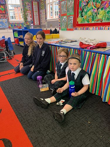 Anna Riley and Mia North keep Poppy Cuthbertson and Eva Munro company while they eat their morning tea