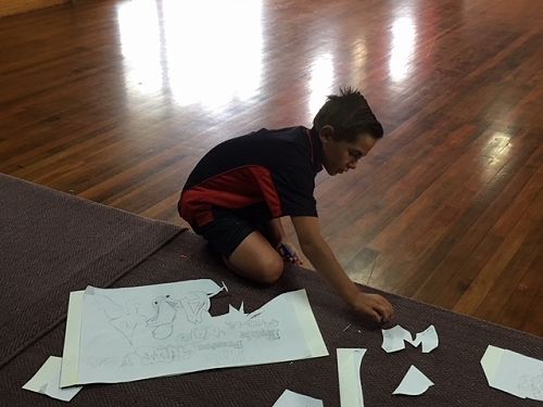 Donte making the stencils for our 'Grafitti' styled lettering for the backdrop.