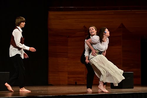 Lysander saves Helena from what could have been her death, while Demetrius looks on.