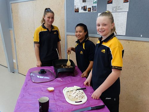 Emily, Charlize, and Amy preparing their tasty dish