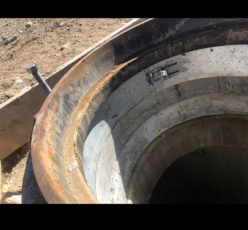 Prototype steel skirt inside top of manhole cover