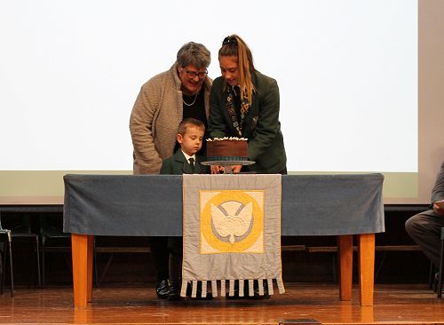 Meg Sycamore and Carson Box, the longest-attending and newest students of Columba, cutting the cake with Mrs P. Duthie looking on. 