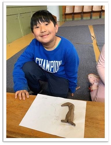 Jeron is showing his clay penguin he created on KIT day in term 3.