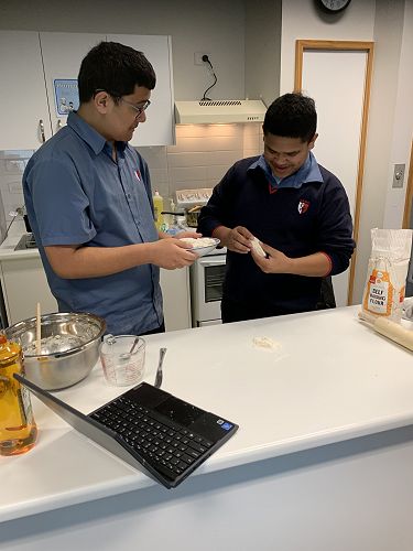 Elijah and Callan trying out Maori bread they cooked