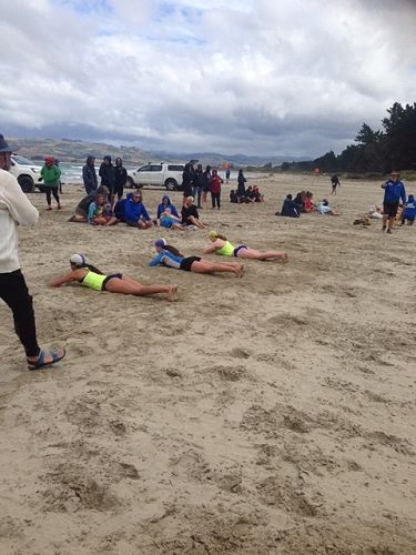Competitors wait to start the beach flag race.