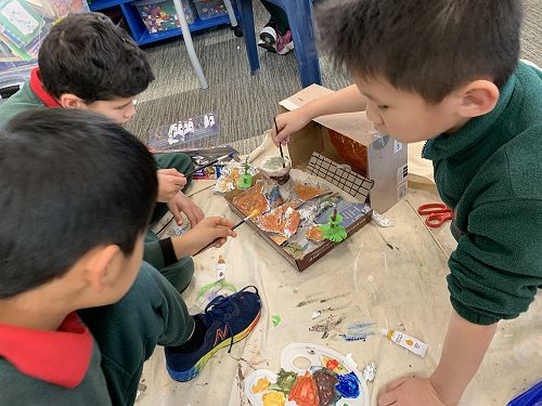 Junhan, Ryan and Ra working on their diorama.