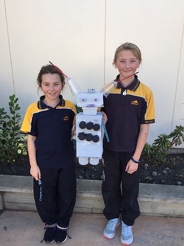 Brooke and Erikah and their robot Snowy.