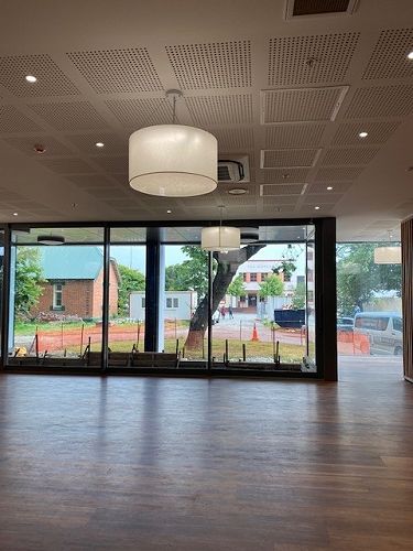 Looking out from the cafe, door open out to green space (former columbarium area)