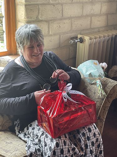 Mrs Duthie opening her gift.