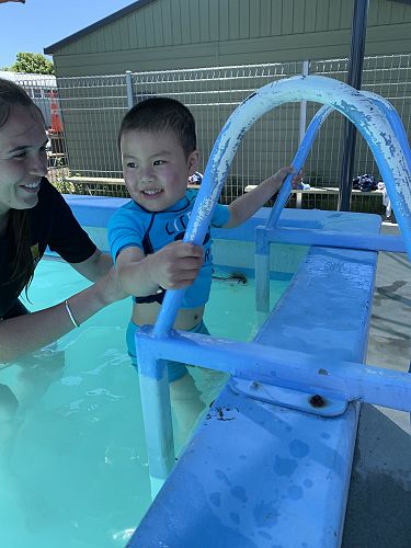 I am practicing getting out of the water safely and turning around at the top of the ladder!