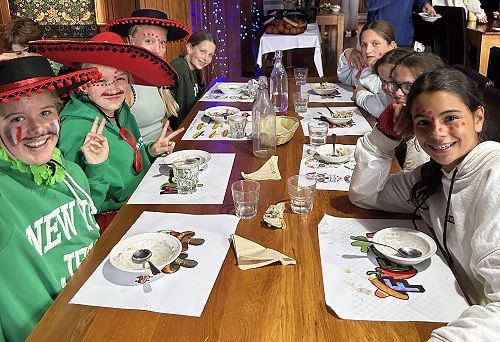 Zara, Olivia, Chloe, Scarlet, Isla, Bree, Kate, and Sadye enjoying Mexican night in the dining room
