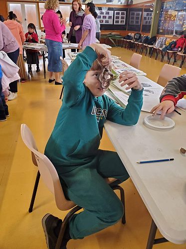 Jake Gillespie is holding up the pottery Zombie he made at our KIT day in Palmerston North.