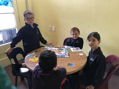 Rakaia, Logan, Faith and Leo enjoying monopoly.