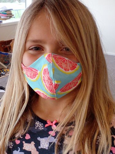 Ruby McIlroy with the colourful mask she made