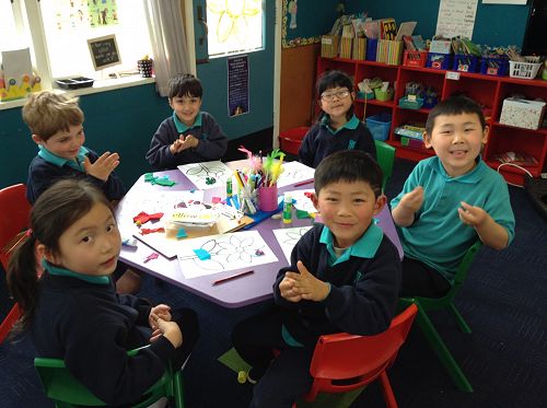 Here are some Room 1 children experimenting with combining different coloured crepe paper to design flowers.
