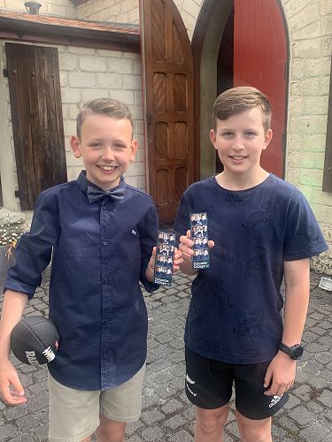 Max Smith and William Henderson with their photos from the photo booth.