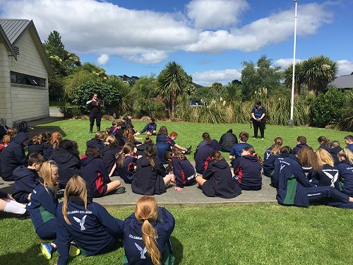 Group hearing stories about the origins of Araiteuru Marae