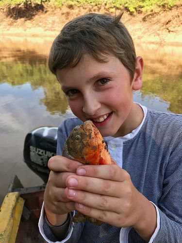 Mateo got the first catch — a red-bellied piranha