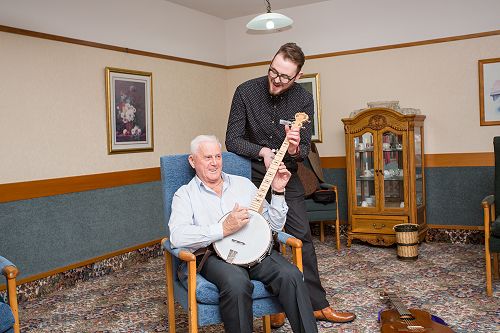 Enliven Music Therapist Jamie MacDonald with Des Tressider enjoying the music enrichment programme