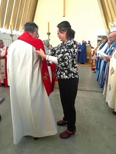 Yvette 'vests' Andrew with his deacon stole