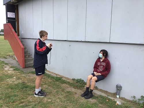 Theo and James supporting each other with their fitness in Y10 PE.