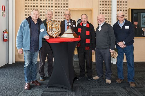 L to R - Former St Bede's Rower's Pete Bartkevics,  Mark Brownlee,  Phil Kinghan,  Fr. Earl Crotty (rowing coach),  Pete Higinbottom,  Mark Craddock with the Springbox Shield, and Maadi Cup.
