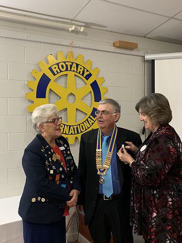 Liz badging Denis at Emerald Changeover.