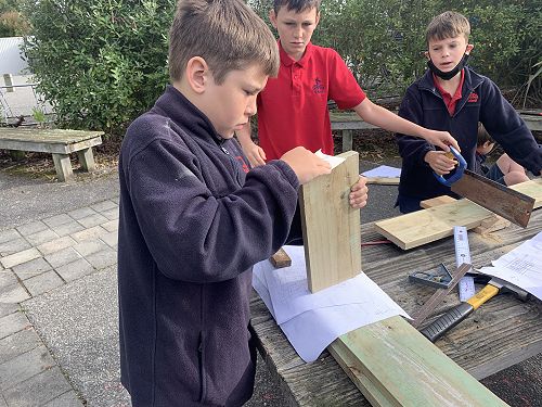 Xion sanding the edges to ensure his pieces fits together well