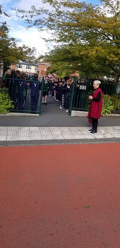 Meg Bowmar walking through the students from the Junior School.