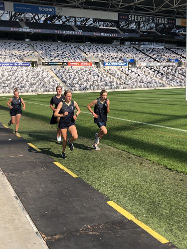 Melanie Button (right) flanked by Columba support runners Lila Rhodes, Isla Nicholson and Anya Rhodes