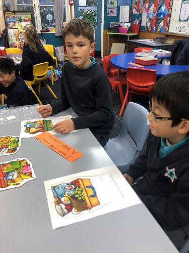 Nikita and William finding out who has what in their lunchboxes.