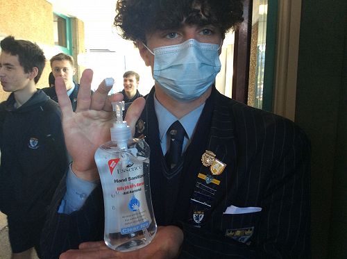 James Nicolson getting ready to sanitize each students hands before they vote
