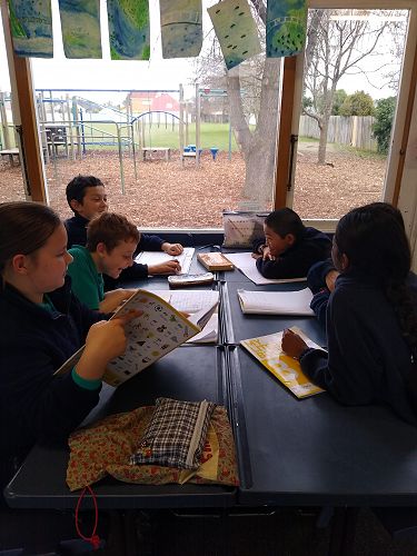 An Artemis Fowl group discussing this week's chapter in their literacy circle