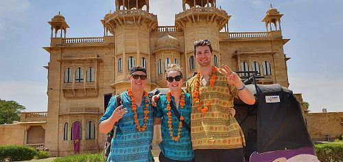 Josh Bardell, Emily Spink and Sean Boult at the finish line after 14 days racing "Rocky" around India