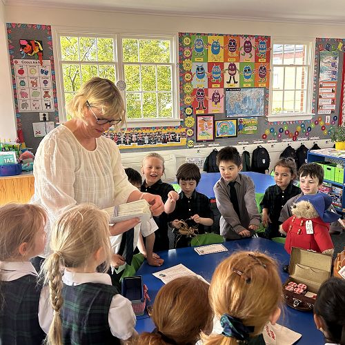 Miss Eason handing out personalised invitations