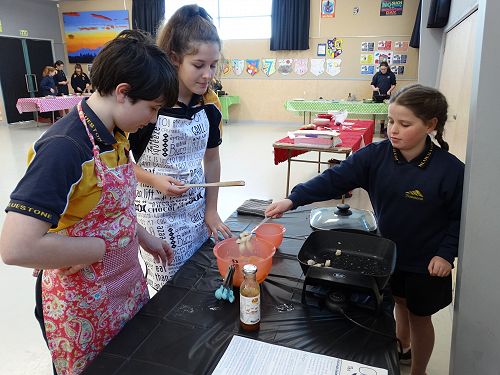 Hayley, Jess and Maddy cooking their dish