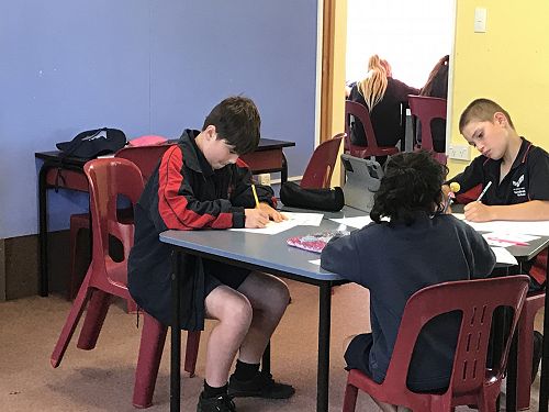 Toby, Soha and Josh working hard on their self portraits.